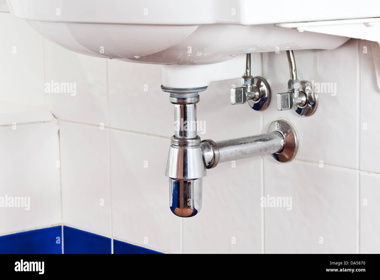 metal sink siphon and drain in white bathroom Stock Photo Alamy