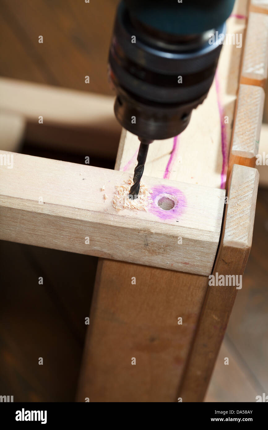 repairing of furniture with drill Stock Photo Alamy