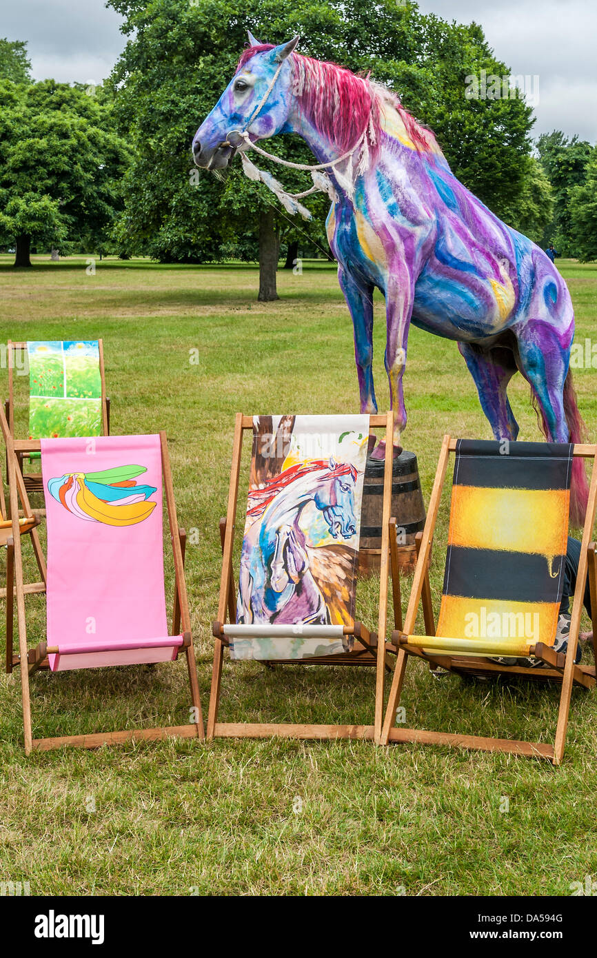 London, UK. 04th July, 2013. Deckchair Dreams is being launched ahead of the forthcoming British Summertime in Hyde Park series of concerts. Pegasus (based on Ronnie Wood’s painting of the same name C) is one of  is one of 20 new designs by people including Harry Enfield (Hello Ducks), Miranda Richardson (Blue with bird), Julia Bradbury (Bee stripes R), Take That’s Howard Donald (Rainbow hands), Chris Beardshaw and Michael Craig-Martin (Pink bananas L). Pegasus was brought to life by Tetua who was hand painted for the occasion. Stock Photo