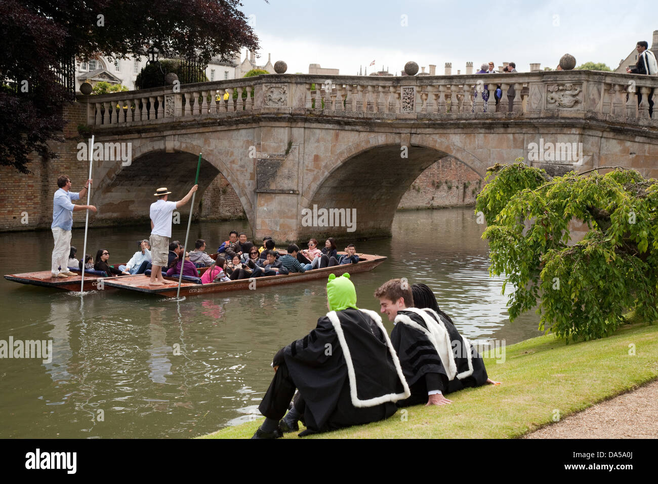 Graduation day Cambridge University; Graduates watching punting on the river Cam on Graduation Day, Cambridge, England UK Stock Photo