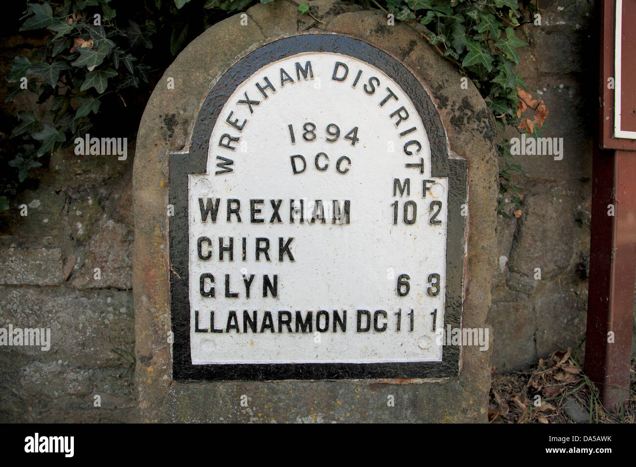 Old mile stone in Chirk village showing miles and furlongs on the old