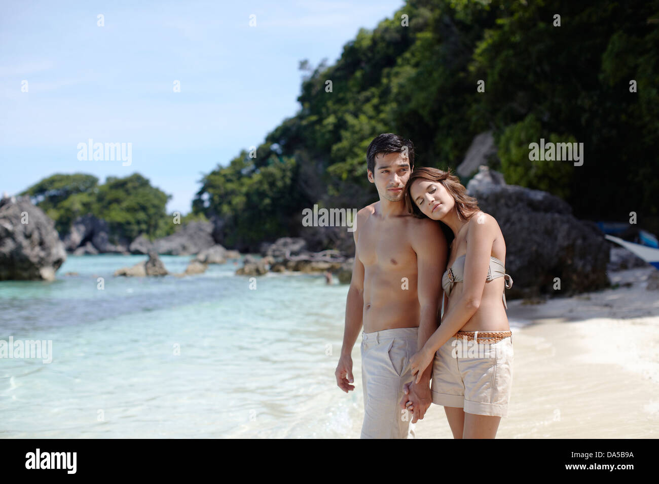 A couple posing on a beach. Stock Photo