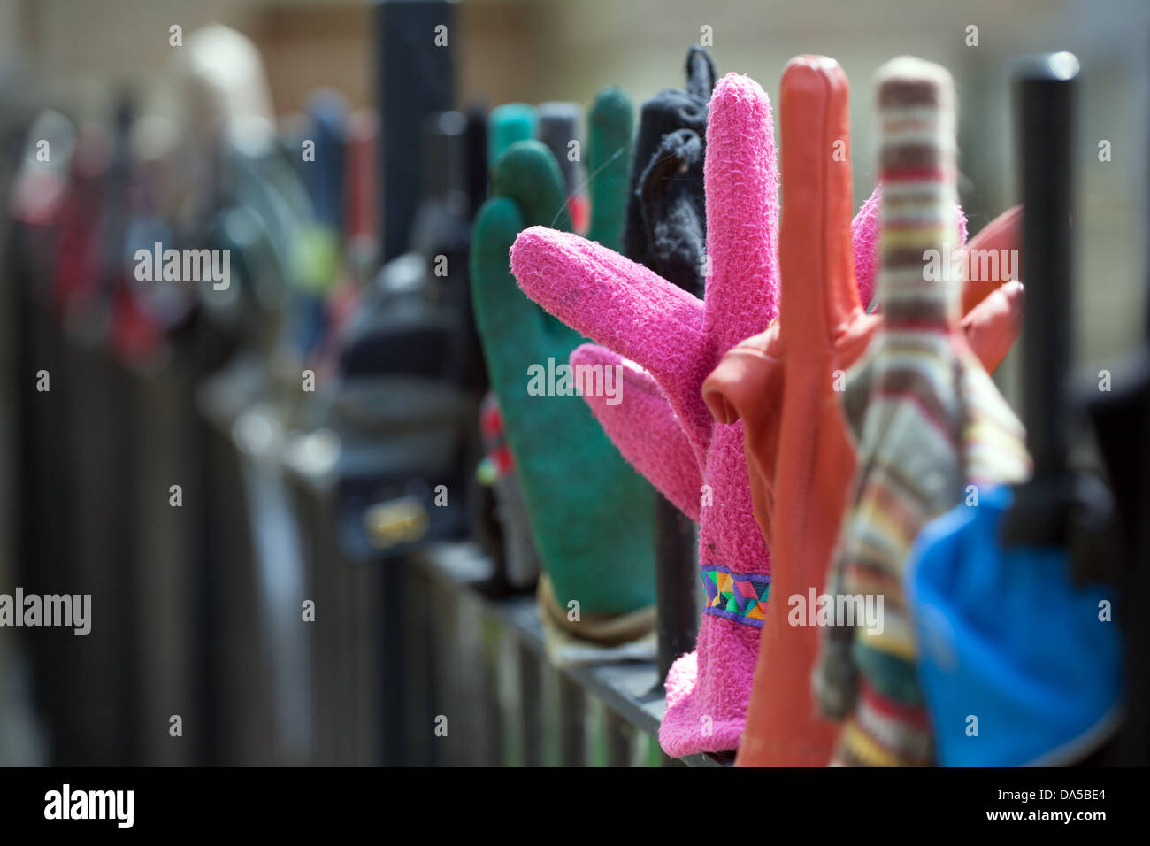 Colourful gloves on wrought iron fence on Tennis Court Road in