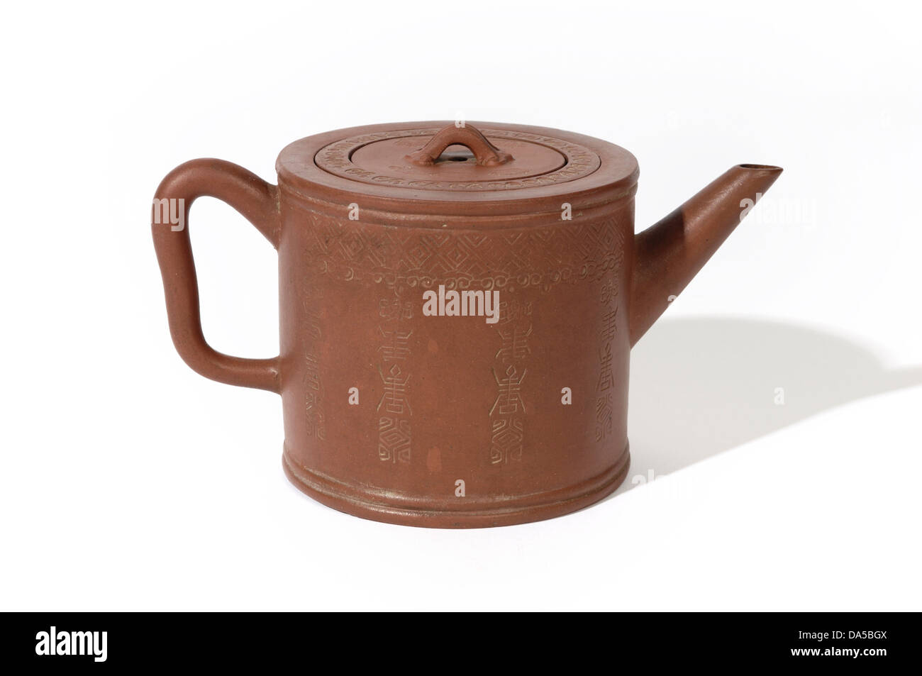 A Chinese Yixing red clay teapot with embossed decoration. Probably 19th C but in and earlier