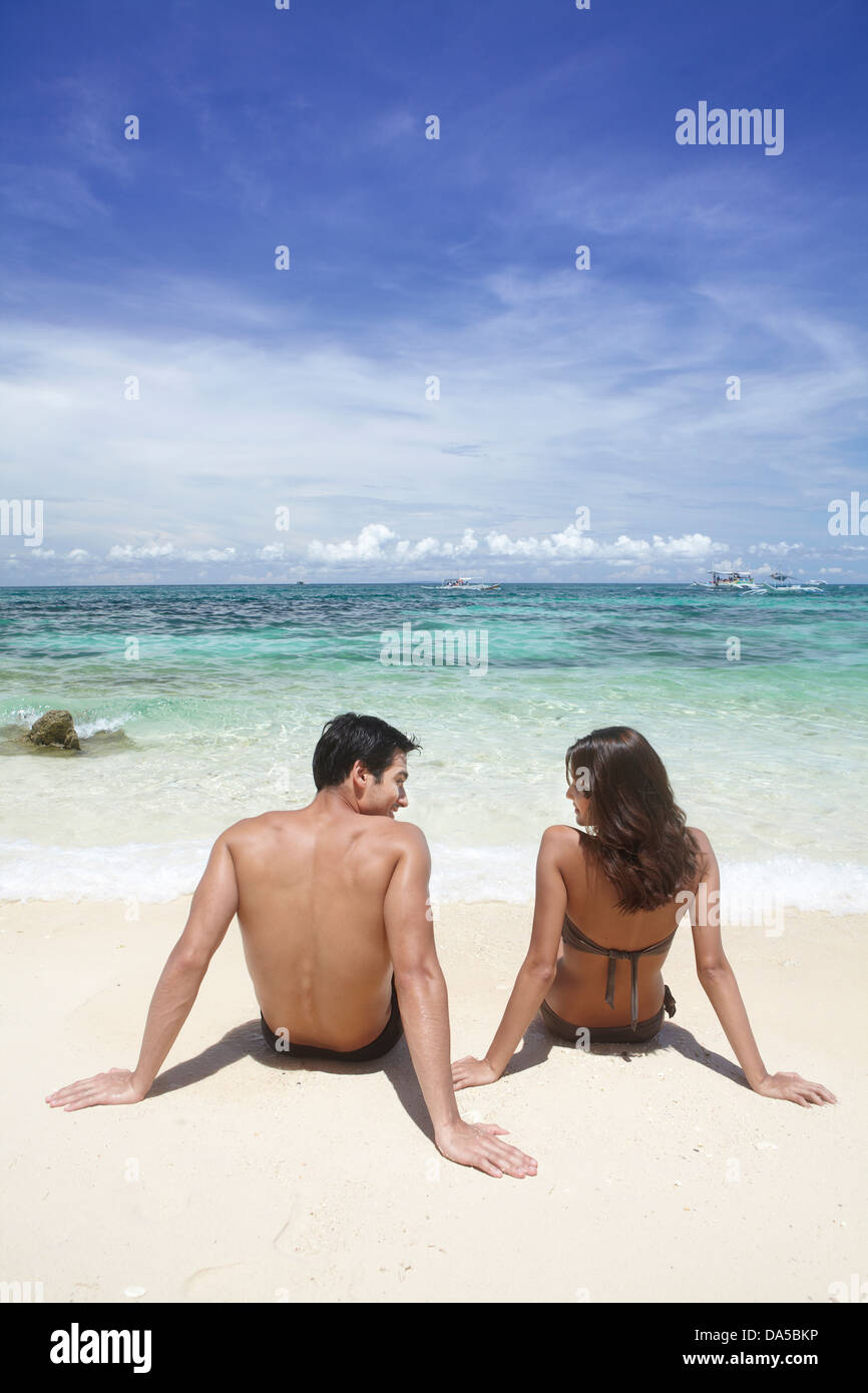 A couple playing on a beach. Stock Photo