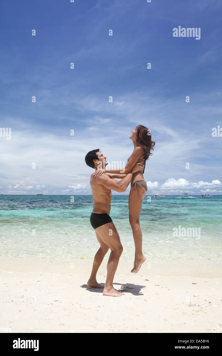 A couple playing on a beach. Stock Photo
