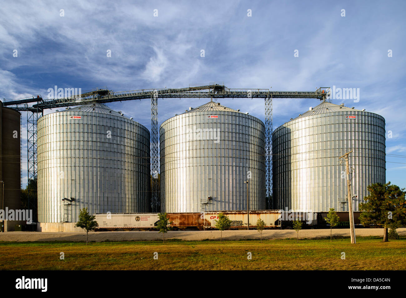 Rail cars await loading at the Shakopee River Terminal grain storage bins. Stock Photo