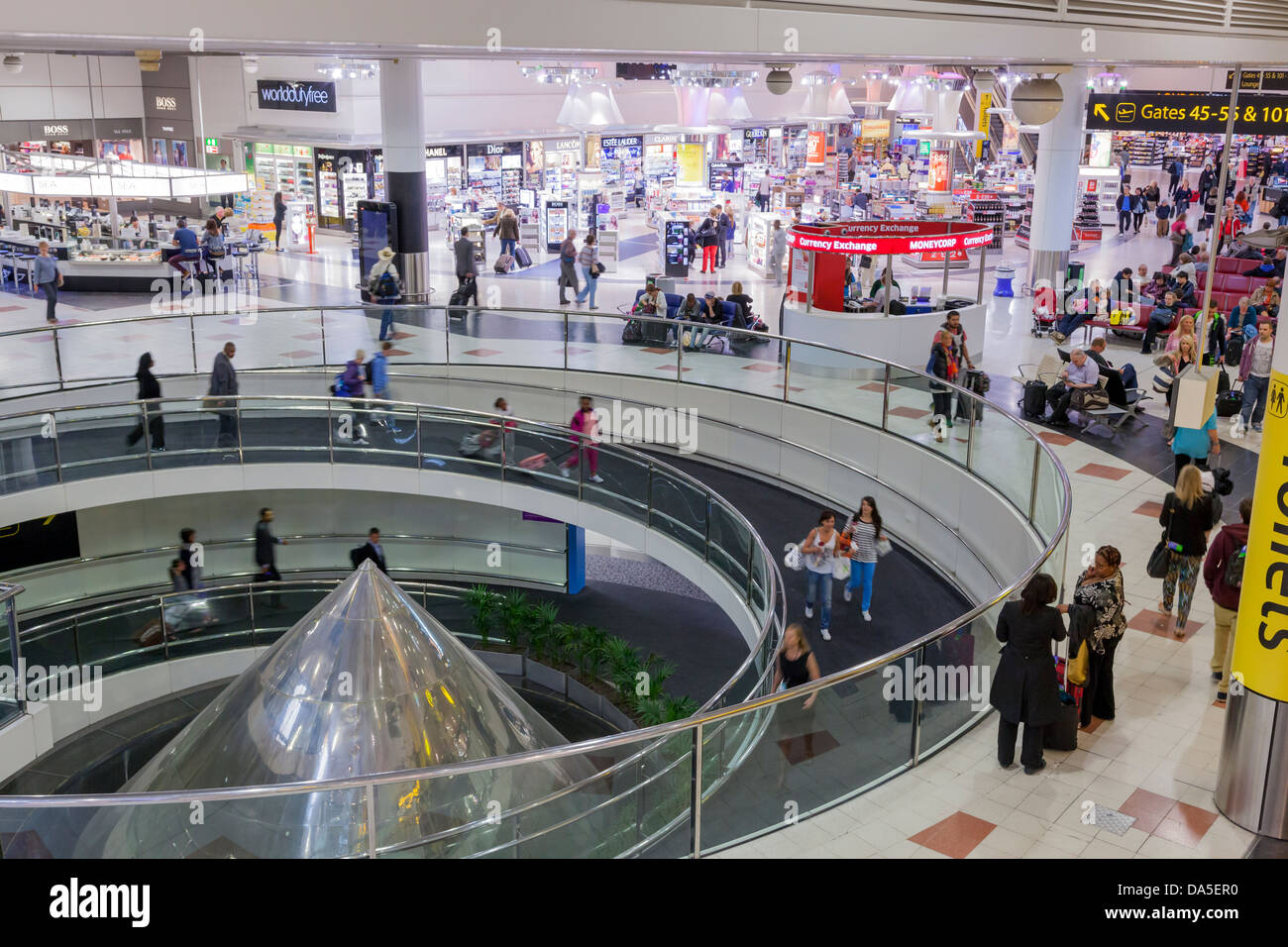 Gatwick airport departure lounge spiral ramp and shops. Stock Photo