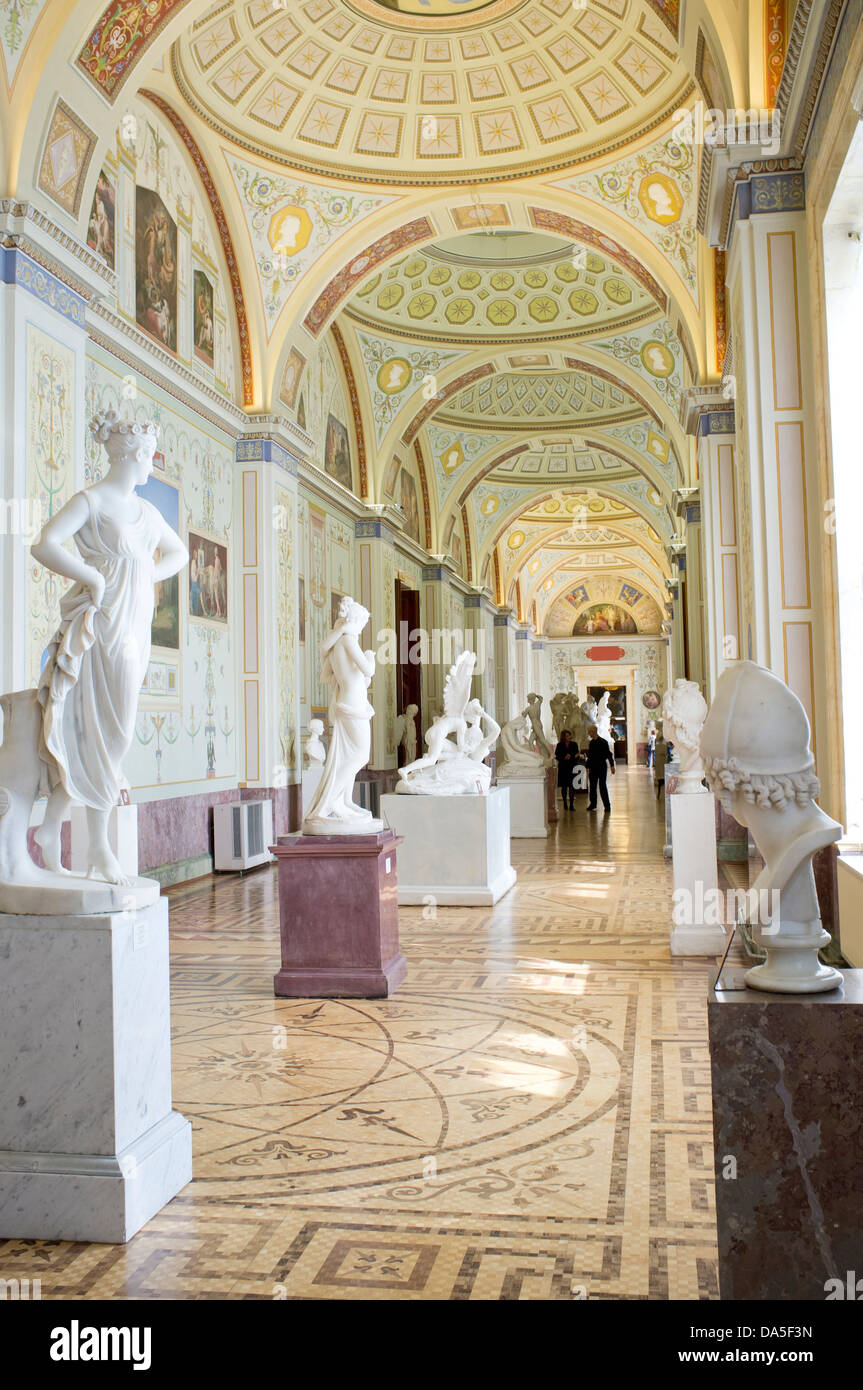 Corridor with decorative ceiling & statues on plinths in State Hermitage Museum, one of largest & oldest museums in world, Stock Photo