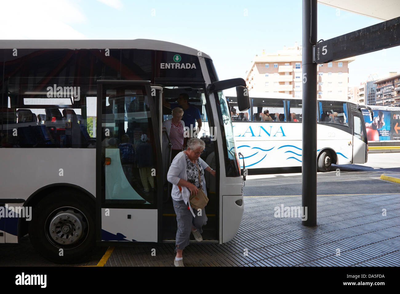 passengers disembarking public bus in bus station in tarragona catalonia spain Stock Photo