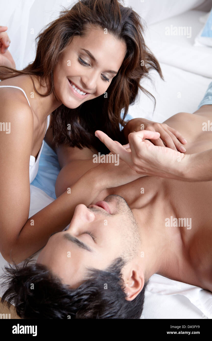 A couple posing on a bed. Stock Photo