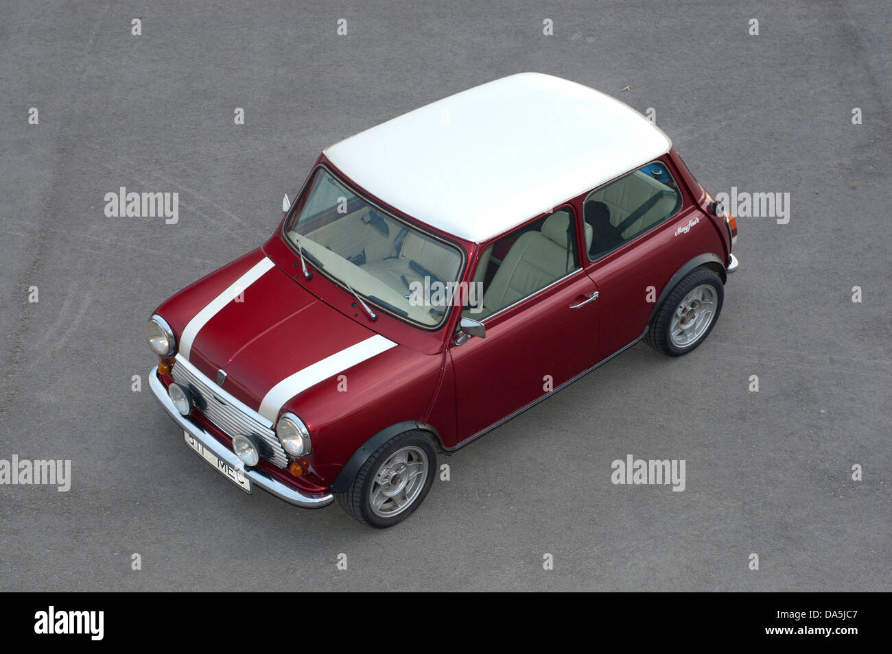 A Red Mini Cooper wth a Union Jack Roof by John Cooper version of the mini  parked on a cobbled street in Huddersfield Stock Photo - Alamy