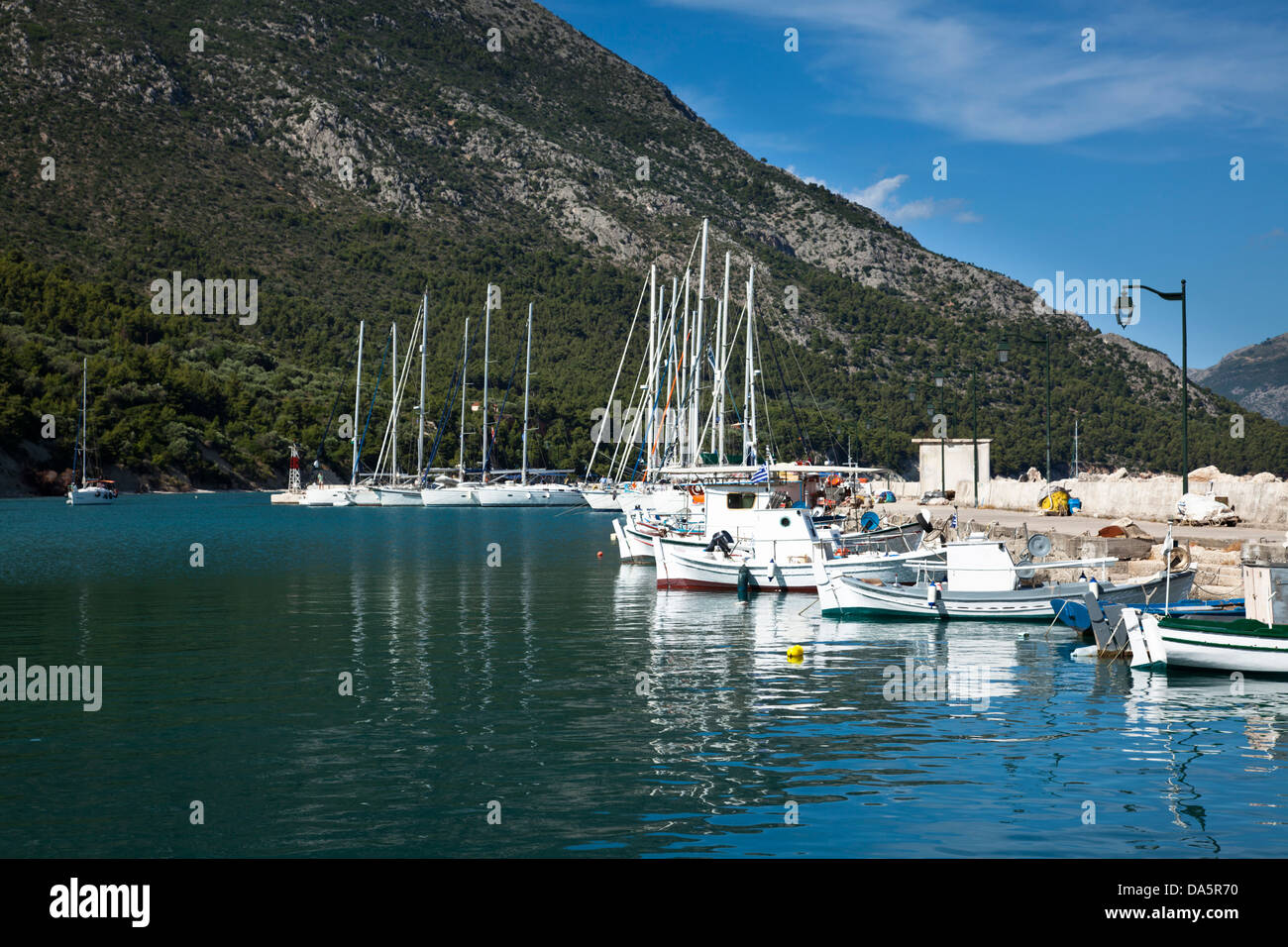 A yacht enters the harbour at Kalamos, Greece Stock Photo