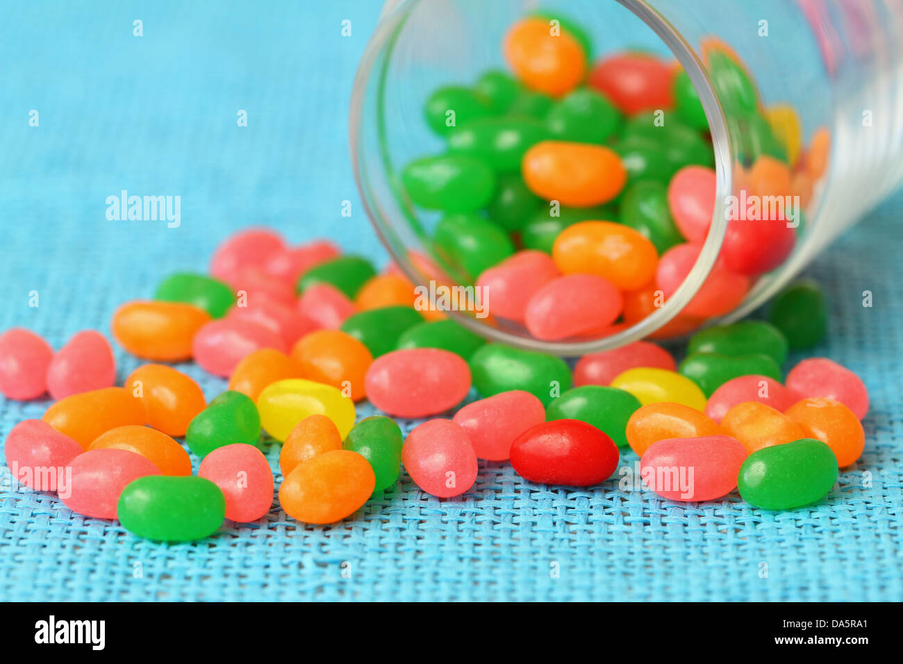 Colorful jelly sweets on blue background with copy space Stock Photo