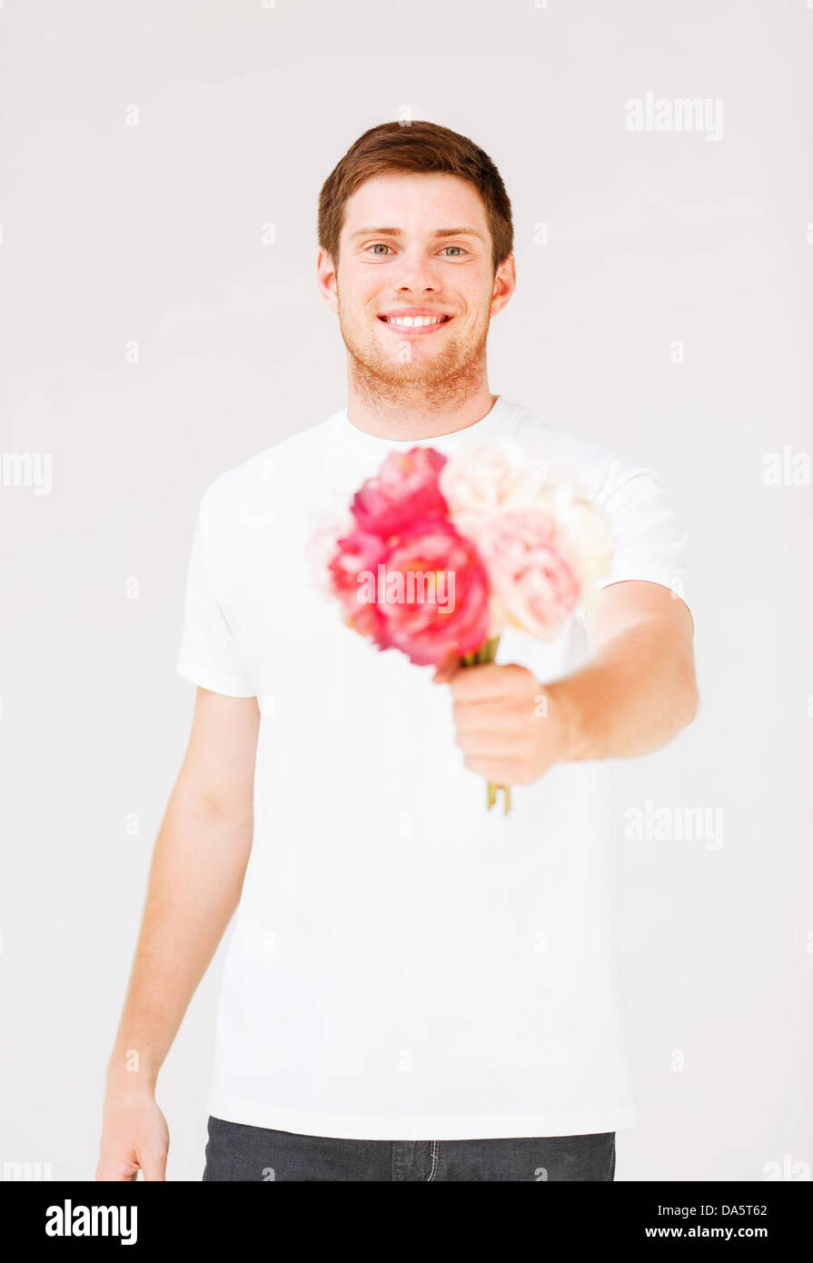 young man holding bouquet of flowers Stock Photo Alamy
