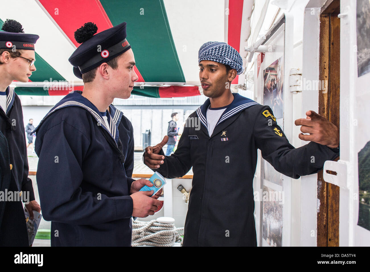 Aarhus, Denmark. 4th July, 2013. Crew member at The Royal Navy of Oman vessel Shabab Oman, introducing the ship to crew members of the Danish vessel Georg Stage, during The Tall Ships Races 2013 in Aarhus, Denmark. The city of Aarhus in Denmark, is the starting point of this years Tall Ships Races. The event includes a fleet of 104 sailing vessels and 3000 crew members from all over the world. Credit:  Michael Harder/Alamy Live News Stock Photo