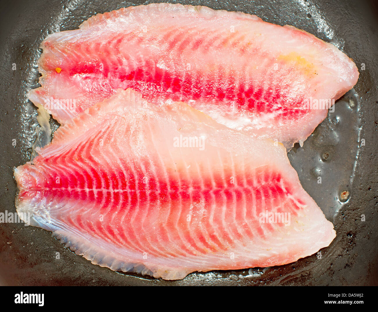 filleted fish on fry-pan Stock Photo - Alamy