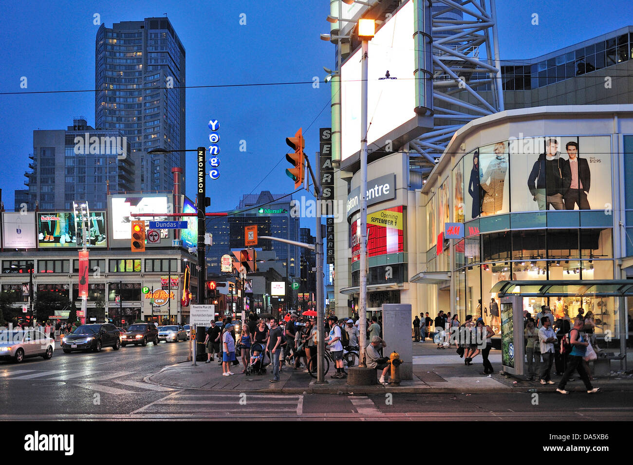 Canada, Dundas Yonge Square, Ontario, Toronto, crosswalk, crowd, dark, dusk, night, people, shopping, shops, sidewalk, sundown Stock Photo
