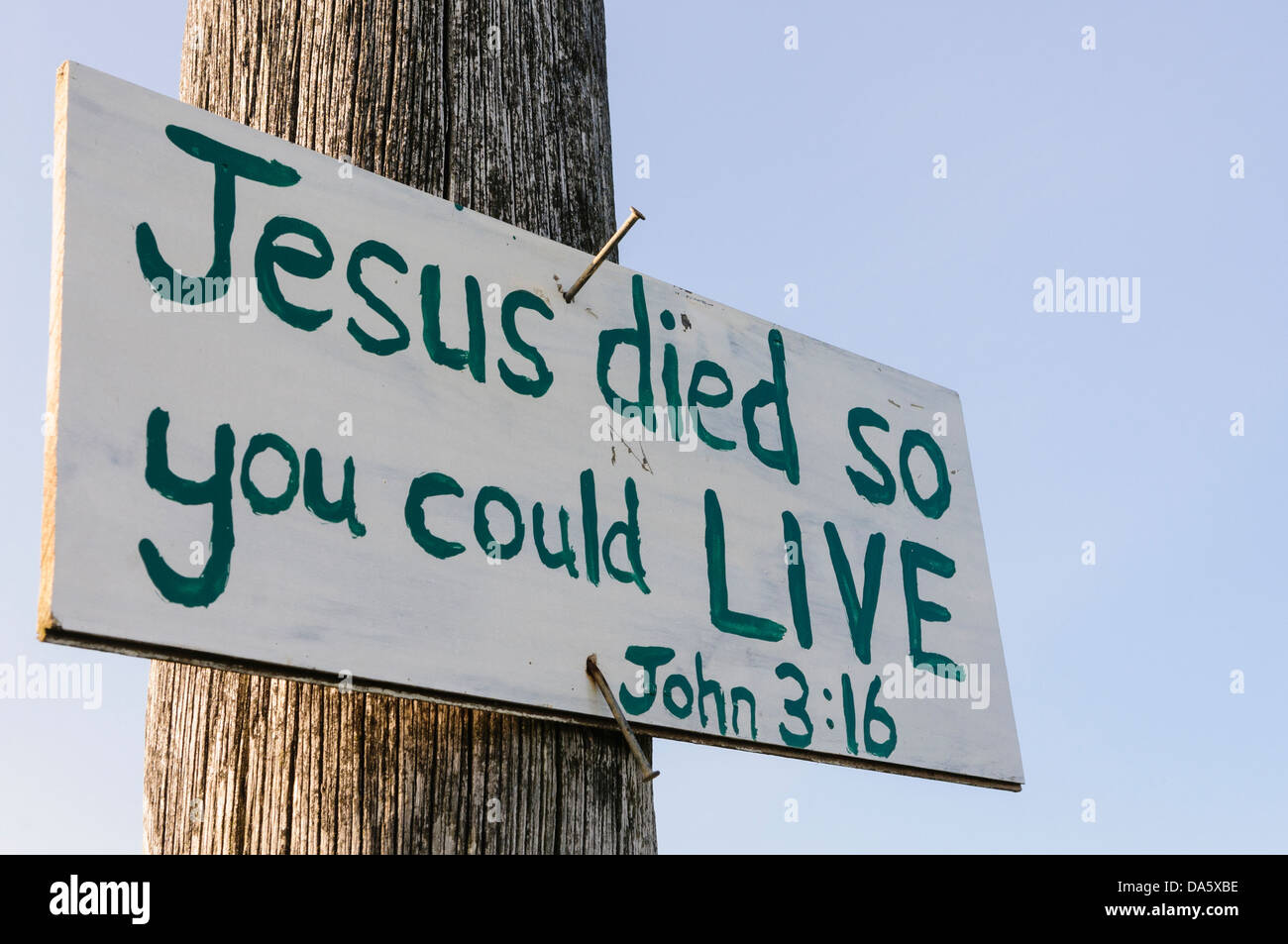 Sign on a lampost with hand-written message 'Jesus died so you could live', typically found in rural parts of Northern Ireland Stock Photo