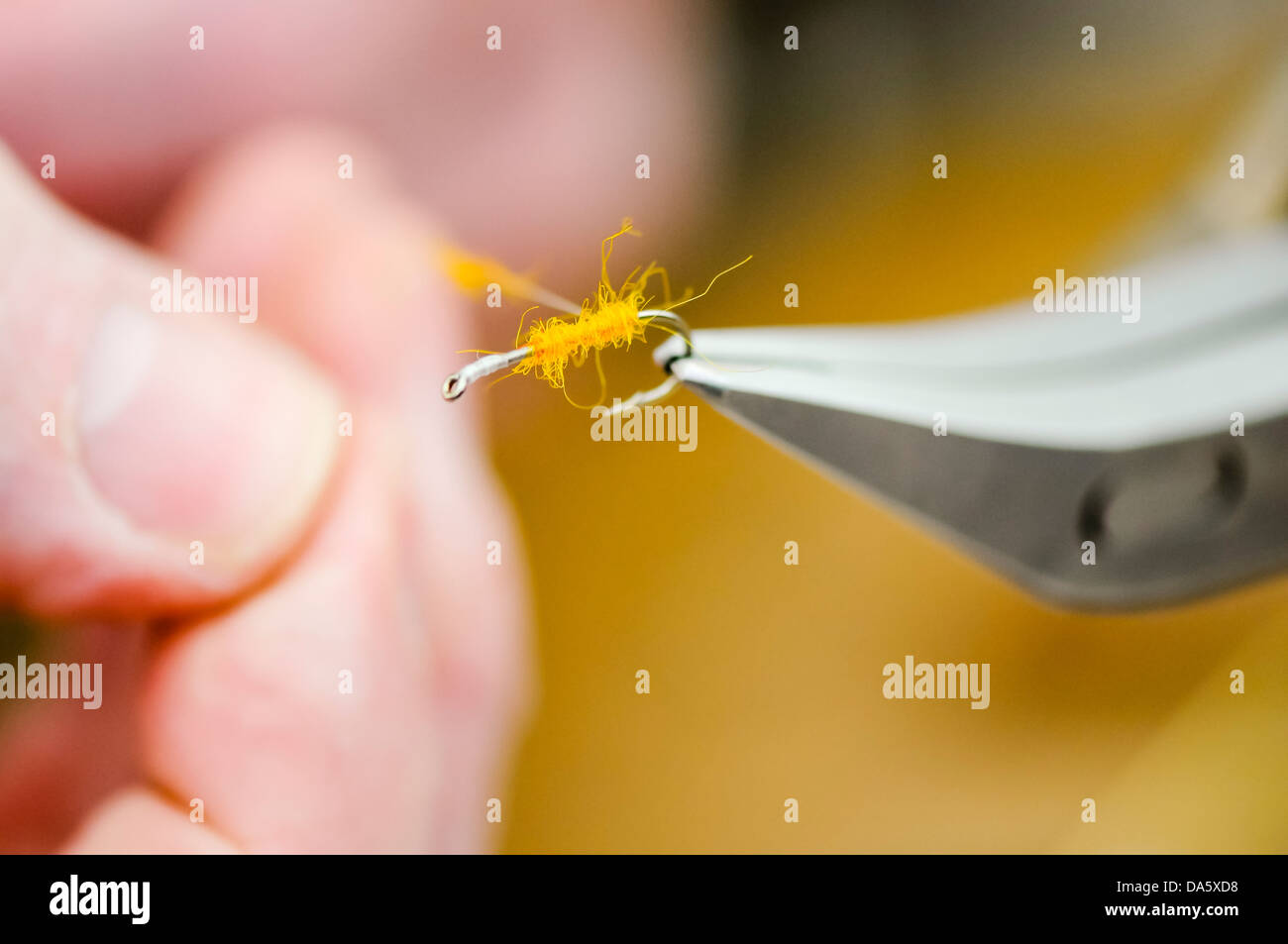 Fly tying demonstration - showing how to add 'dubbing' to the body shank of the fly. Stock Photo