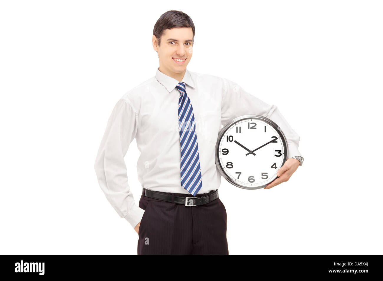 Smiling guy in suit holding a clock isolated on white background Stock Photo