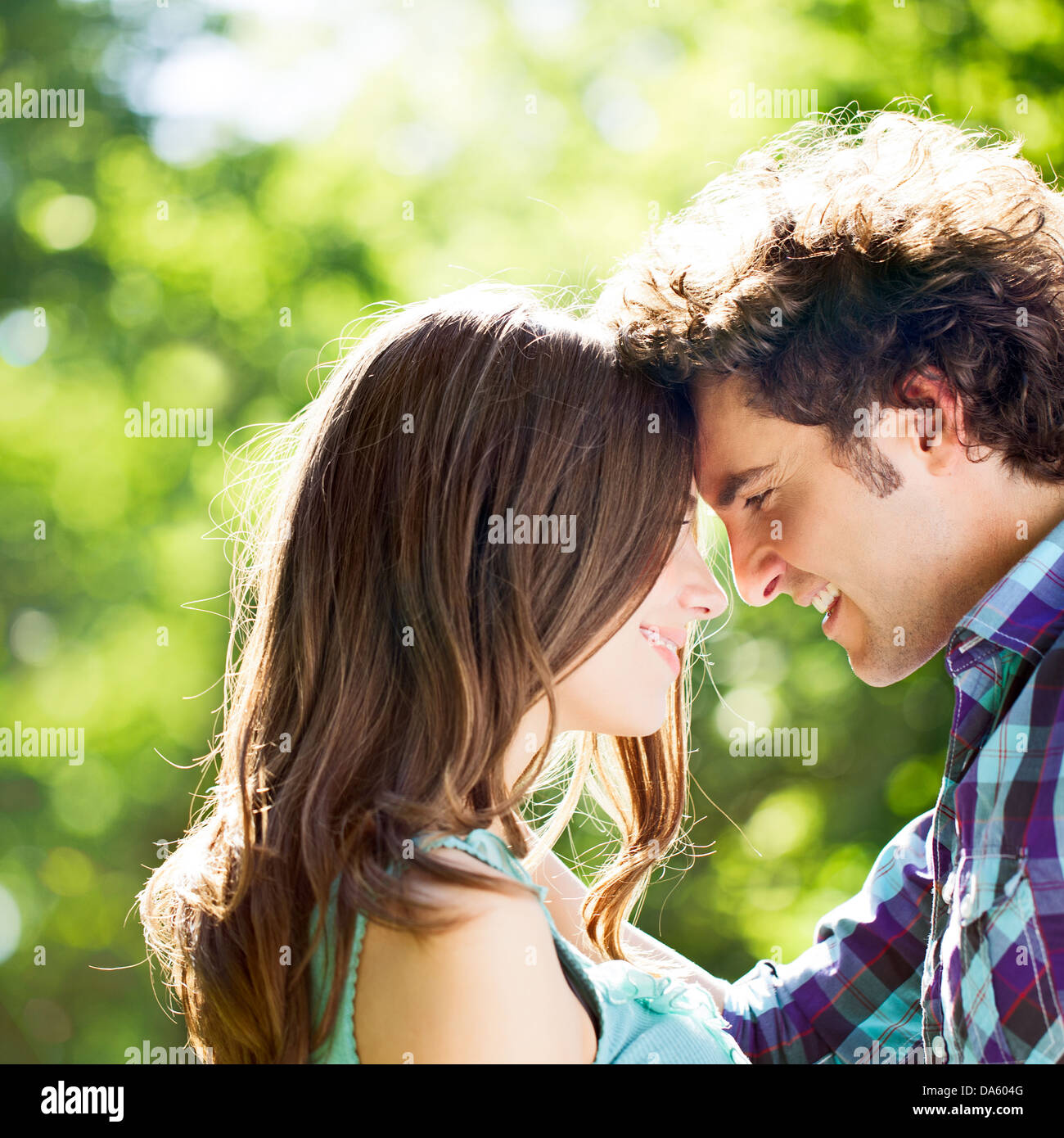 A happy couple standing face to face and smiling. Stock Photo