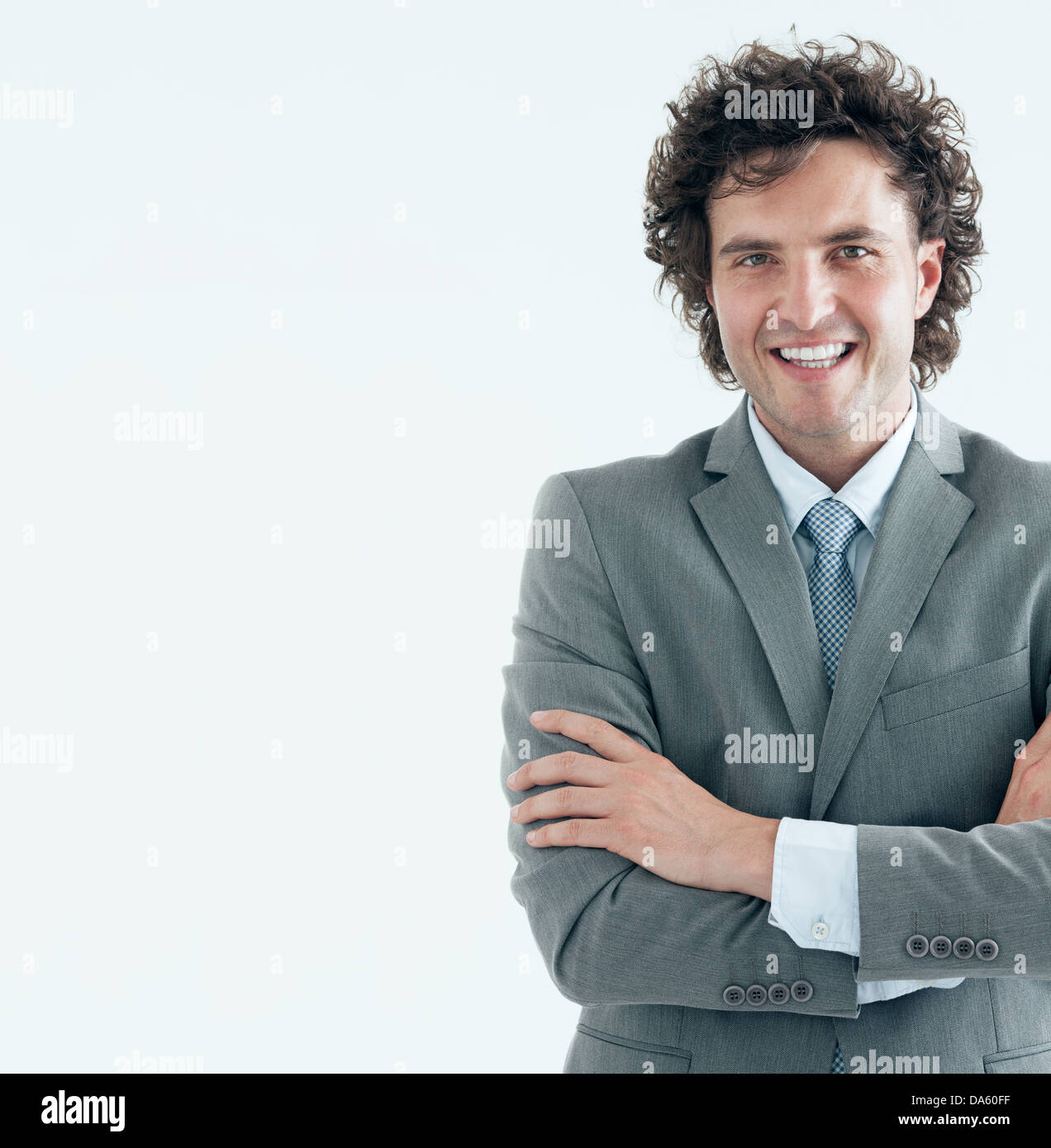 Portrait of a handsome young businessman smiling at the camera. Studio ...