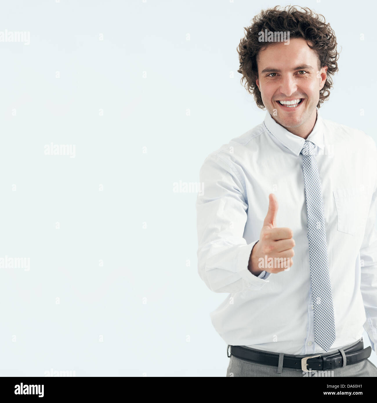Close-up of a successful young businessman showing thumbs up. Stock Photo