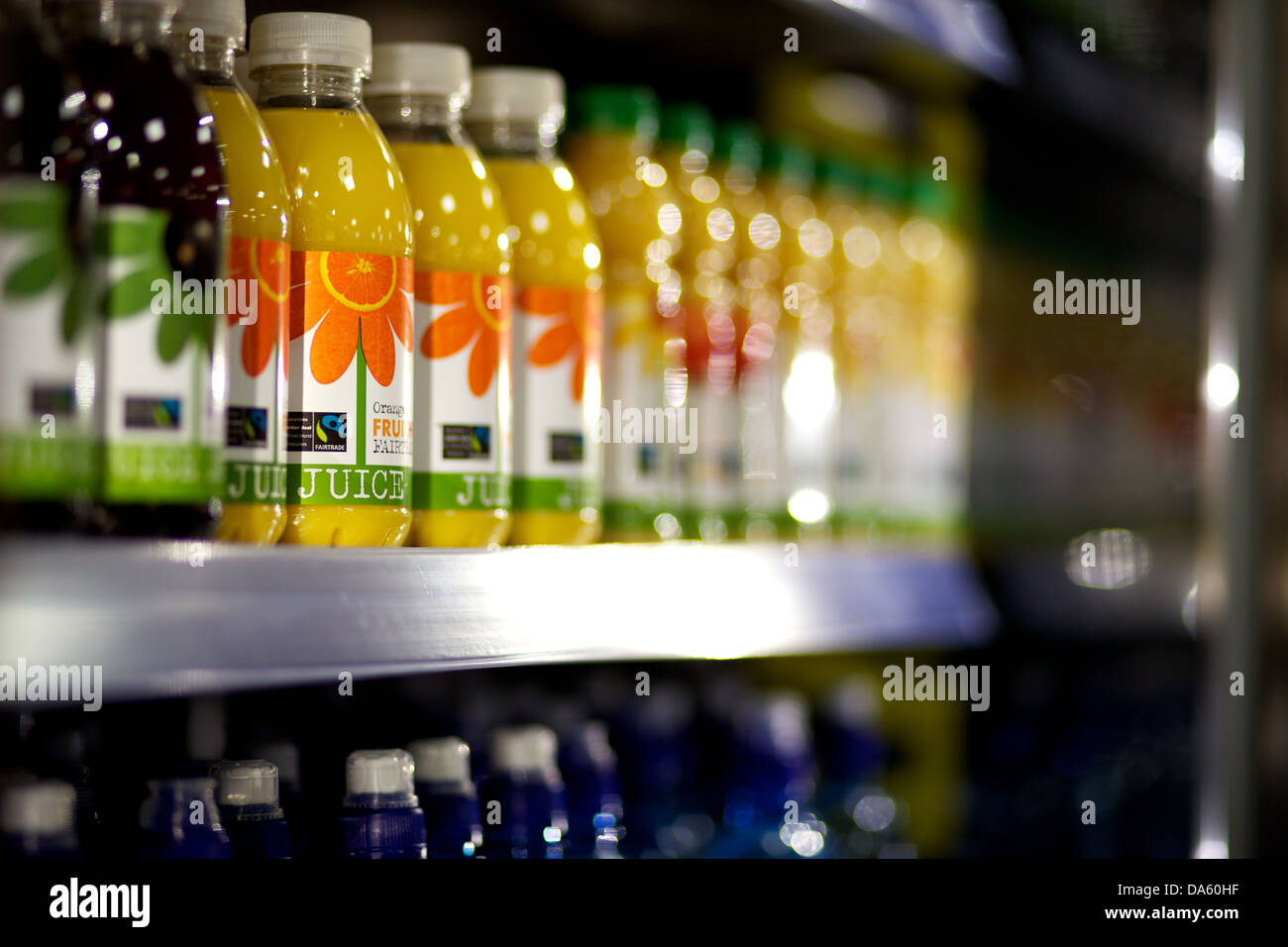 https://c8.alamy.com/comp/DA60HF/bottles-of-water-and-juice-on-a-supermarket-shelf-DA60HF.jpg