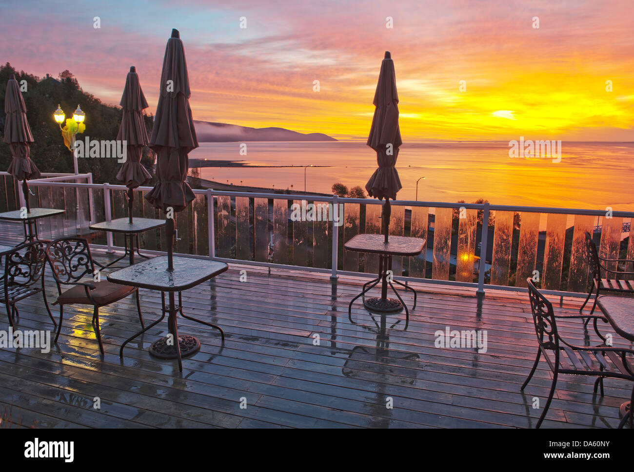 Terrace, Gite Mer et Montagne, St. Lawrence River, river, Malbaie, Quebec, Canada, sunset, tables, chairs Stock Photo