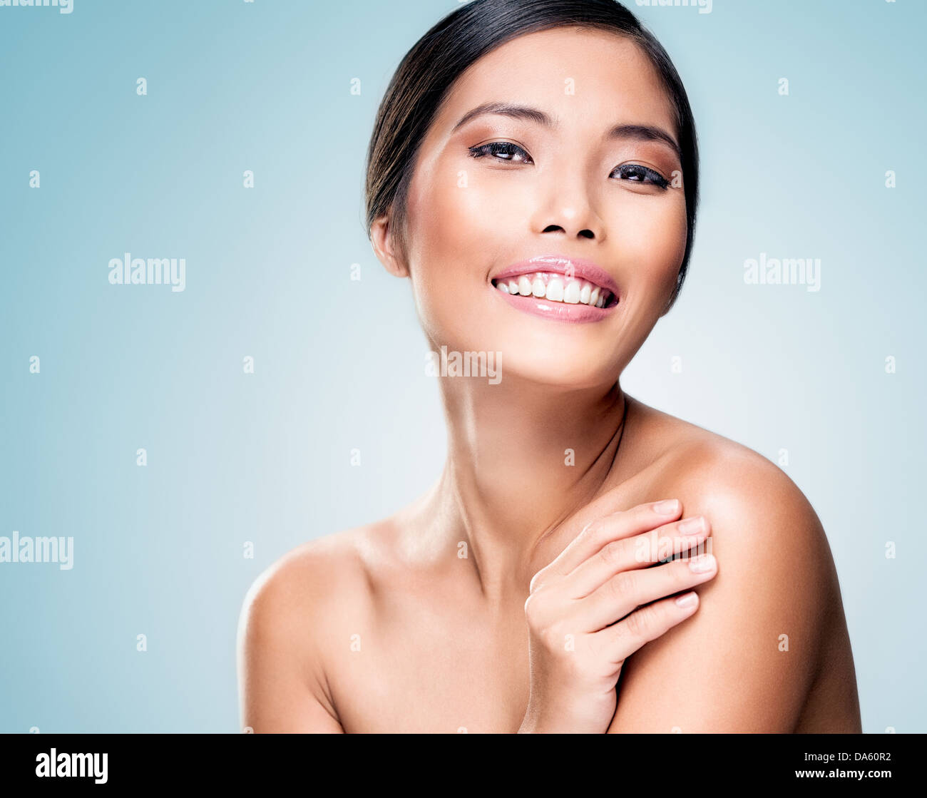 A beautiful Asian model posing and smiling. Stock Photo