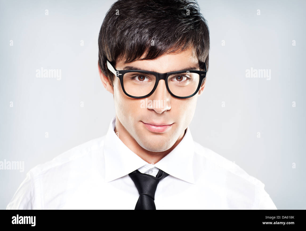 Close-up portrait of young handsome businessman with black eyeglasses. Looking at camera. Stock Photo