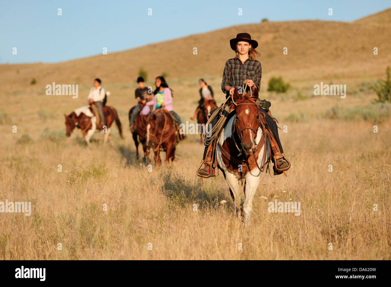 Pacific Northwest, Oregon, USA, United States, America, riding, horseback, sport, horse, ranch, dude, grass, group, girls Stock Photo