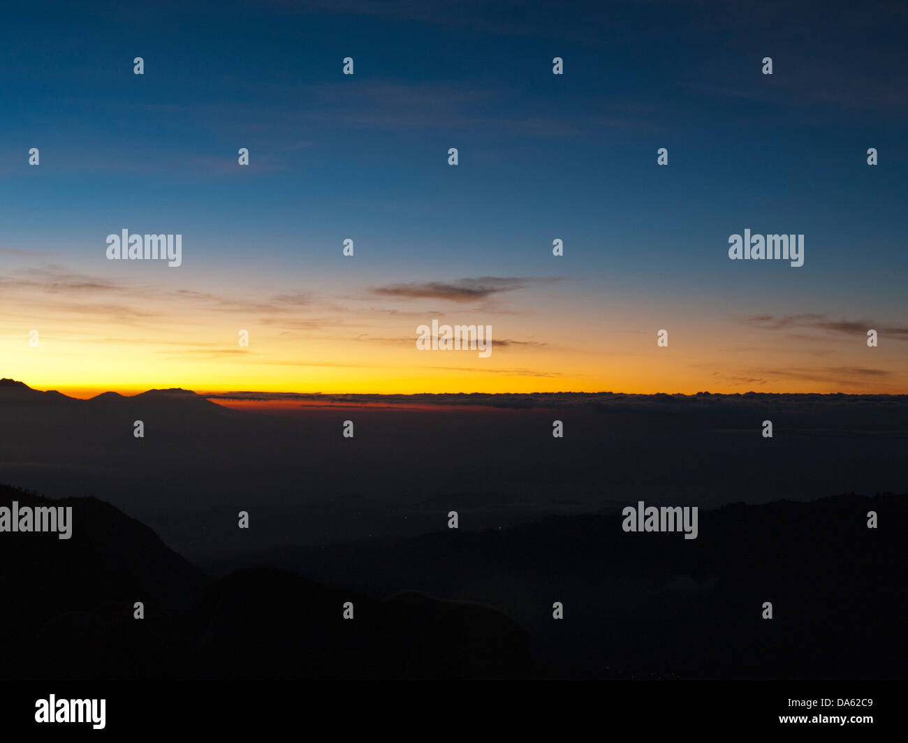 Dawn light behind the mountains Stock Photo