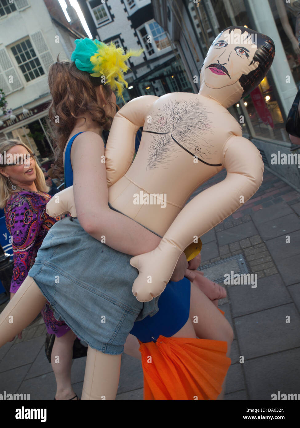 On a hen do an inflatable male doll is carried through Brighton Stock Photo