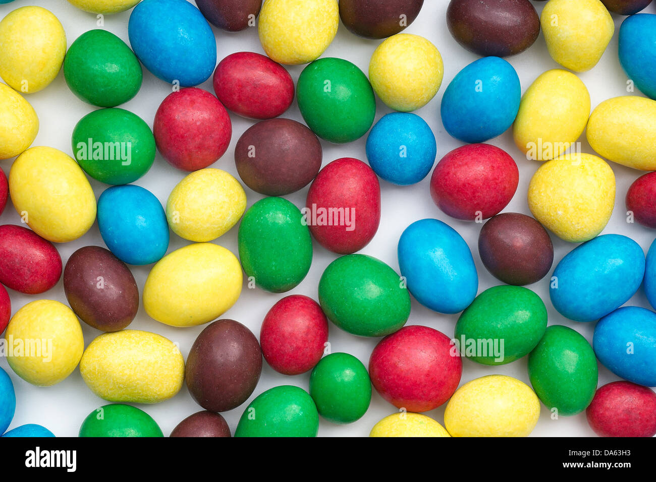Colored candy on white background Stock Photo - Alamy