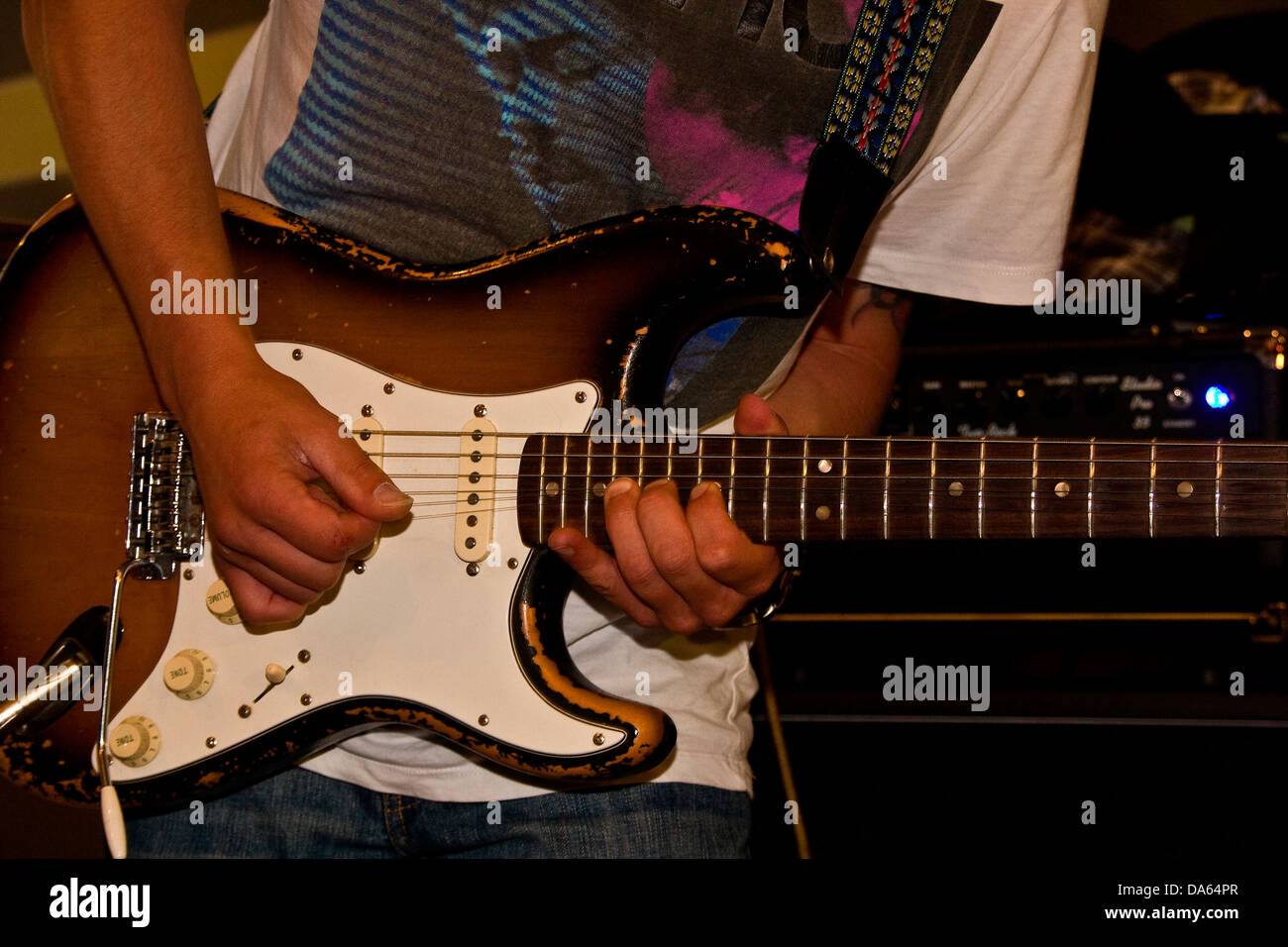 Lee Wharton of The After Hours Blues Band bending the strings of a Fender Stratocaster during a live performance in Dundee, UK Stock Photo