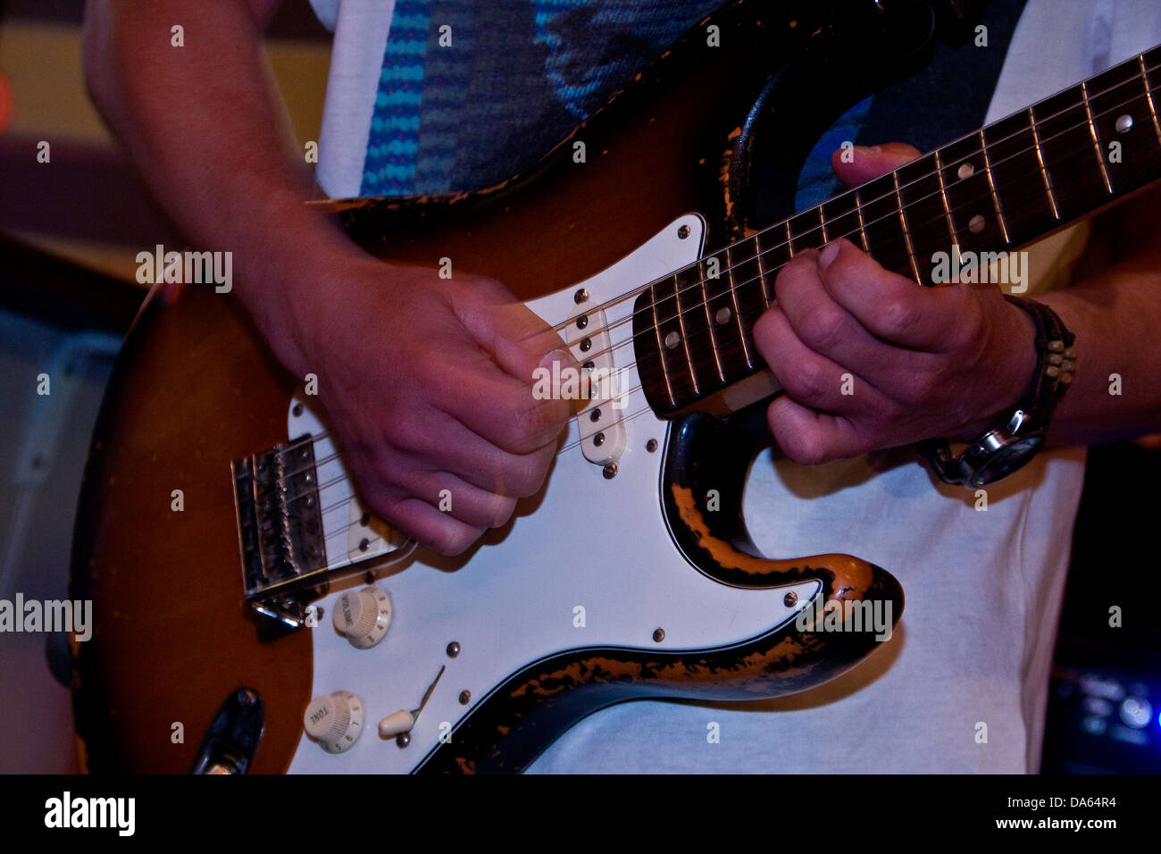 Closeup of Lee Wharton playing the Fender Stratocaster during a live performance at The Klozet pub in Dundee, UK Stock Photo