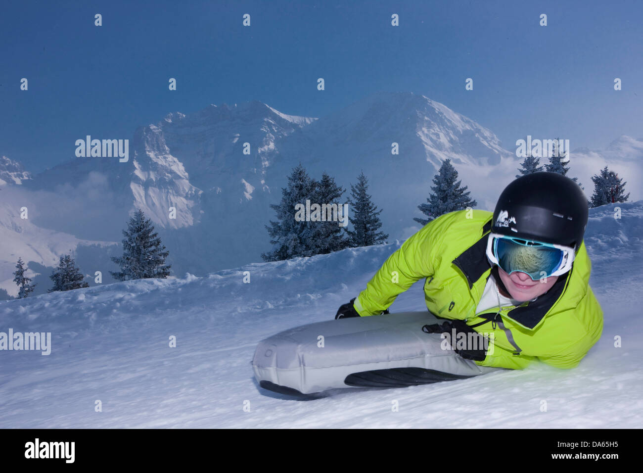 Snowtubing, snow tubing, Adelboden, tourism, holidays, footpath, winter, winter sports, canton, Bern, Bernese Oberland, Switzerl Stock Photo