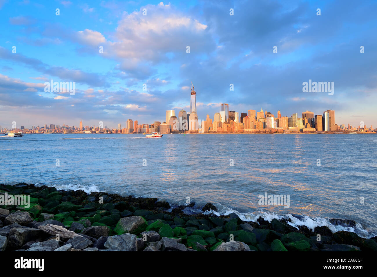 Downtown Manhattan skyline at sunset over Hudson River in New York City ...