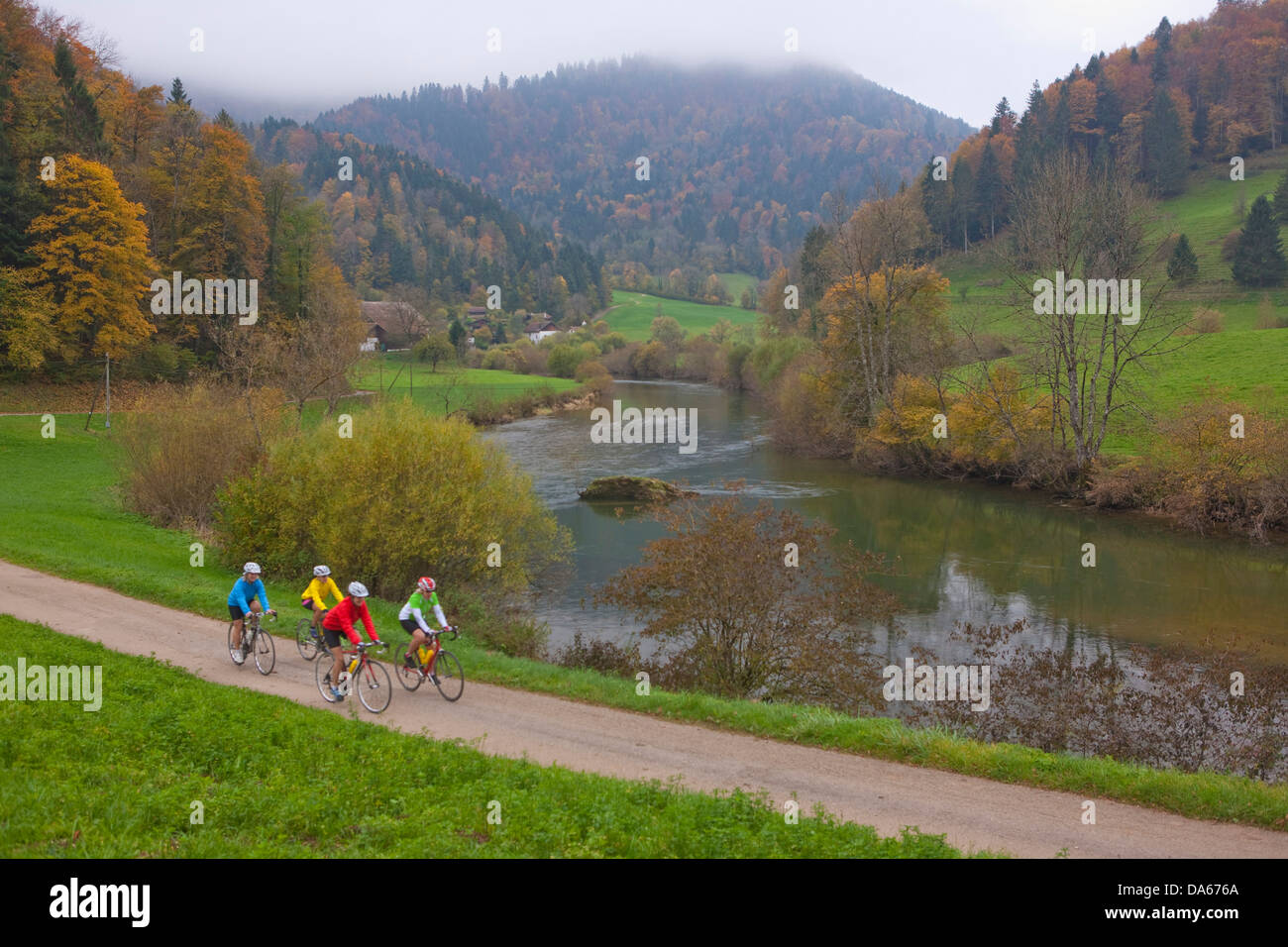 Cyclist, biker, Doubs, Goumois, canton, JU, Jura, autumn, bicycle, bicycles, bike, riding a bicycle, river, flow, brook, body of Stock Photo