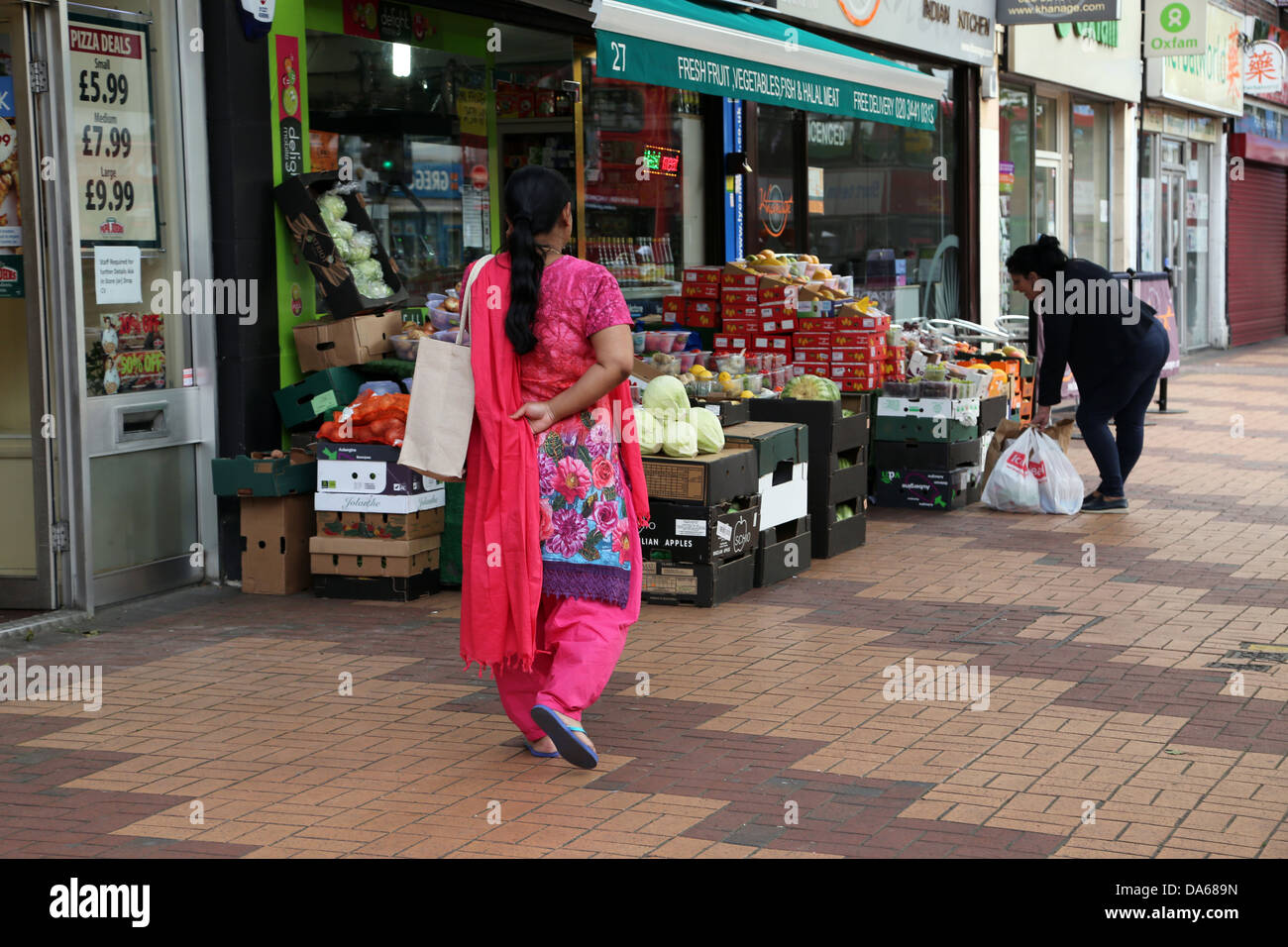 Morden london England Women Shopping Walking Past Green Grocers Stock Photo