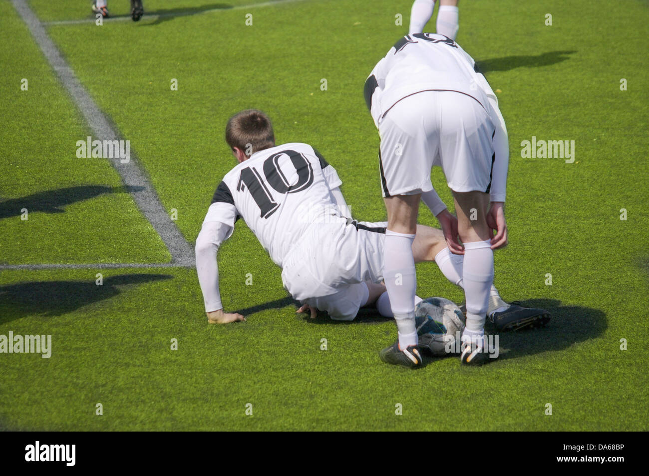 Soccer players collide while trying to score. Who says soccer is not a contact sport? Stock Photo