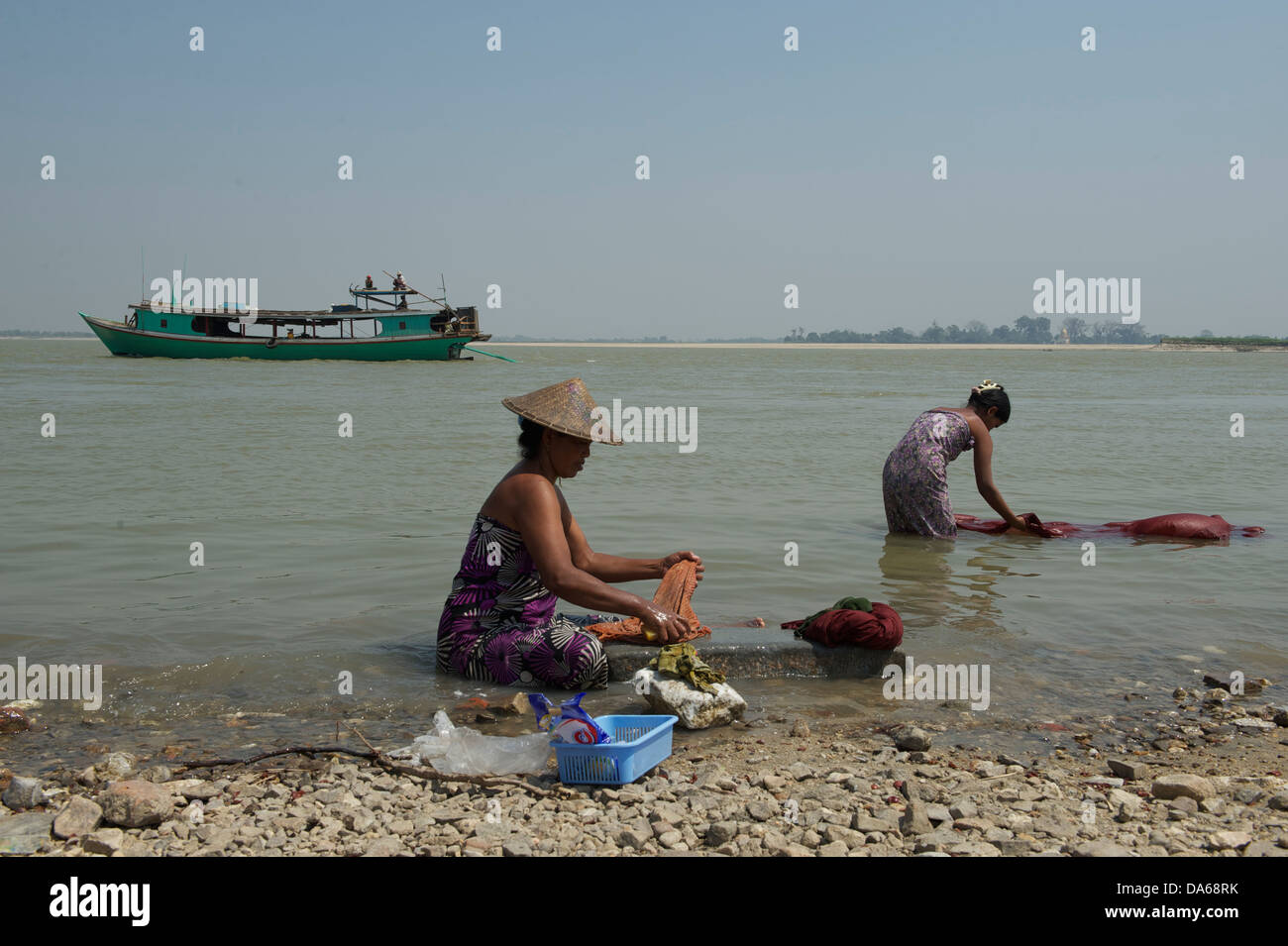 people washing clothes on the banks of Irrawaddy river near Mingun town Stock Photo