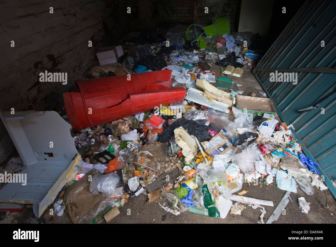 Rubbish filled derelict garage on back alley in Leeds West Yorkshire