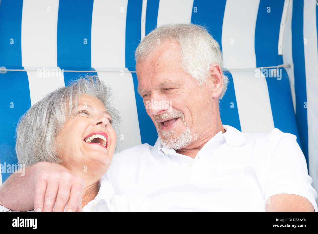 Happy and smiling senior couple in a beach chair Stock Photo - Alamy