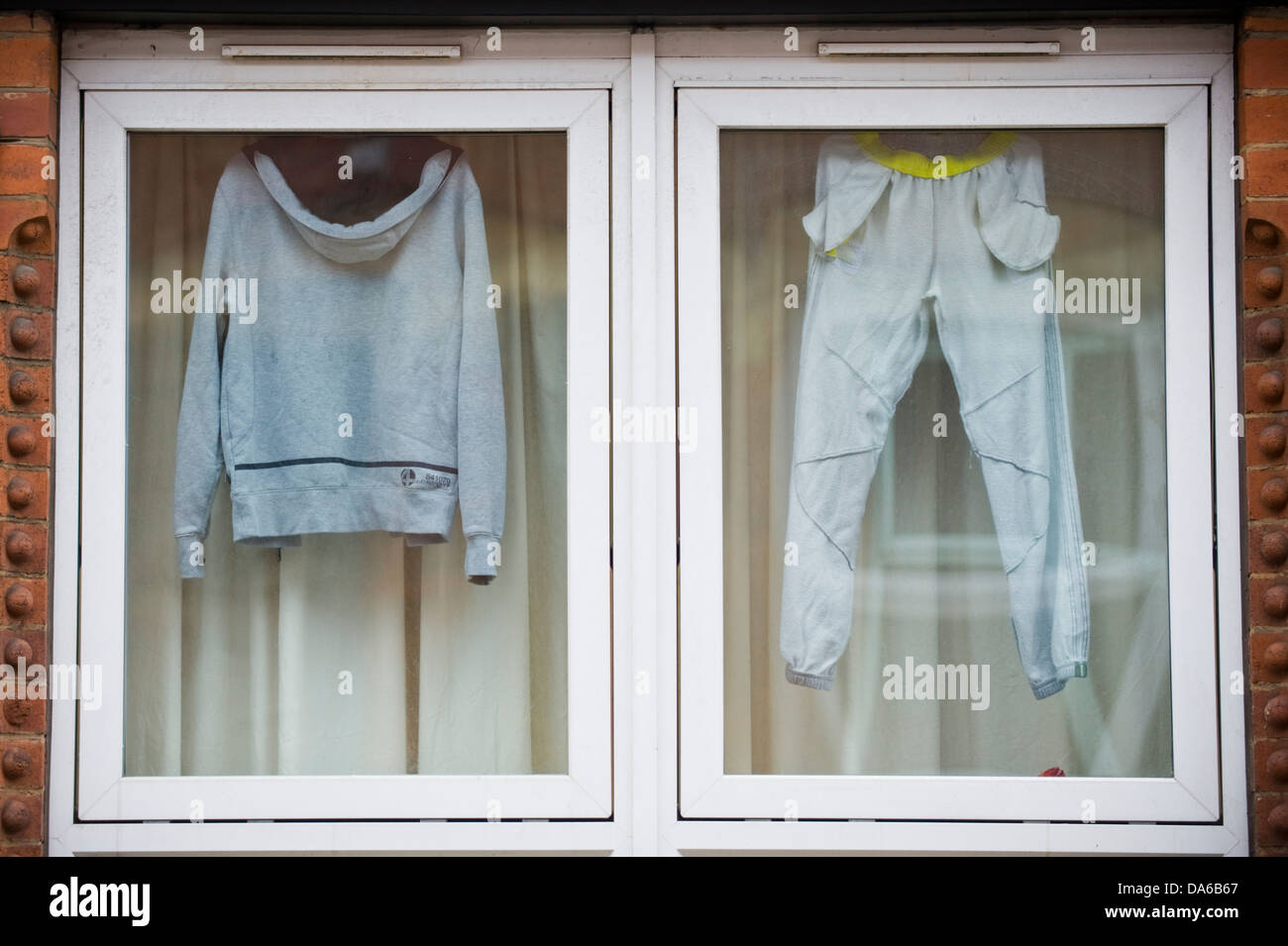 Tracksuit hanging in window of house in Leeds West Yorkshire England UK Stock Photo