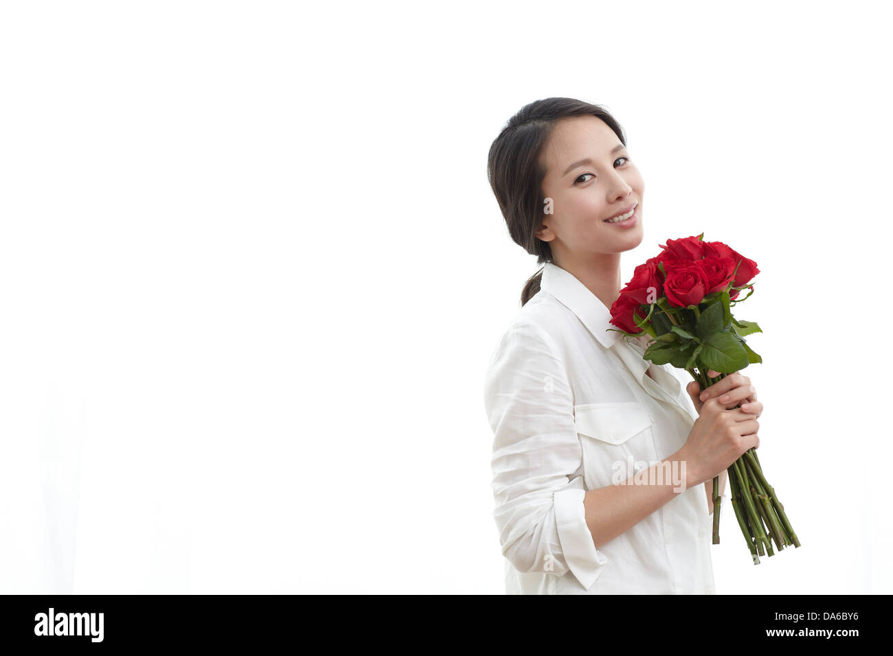 A young woman posing with flowers Stock Photo - Alamy