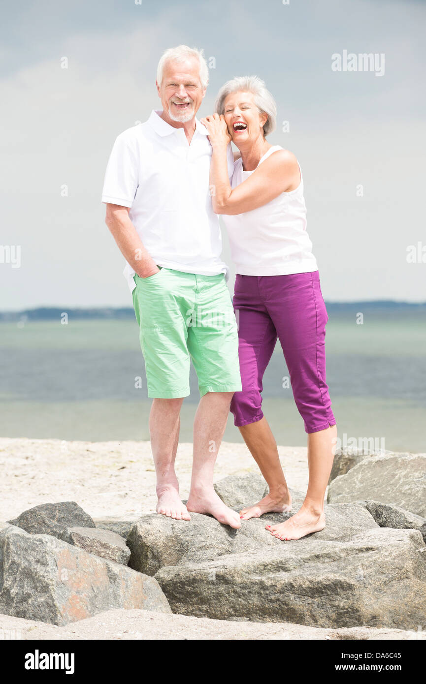 Happy and smiling senior couple at the beach Stock Photo - Alamy