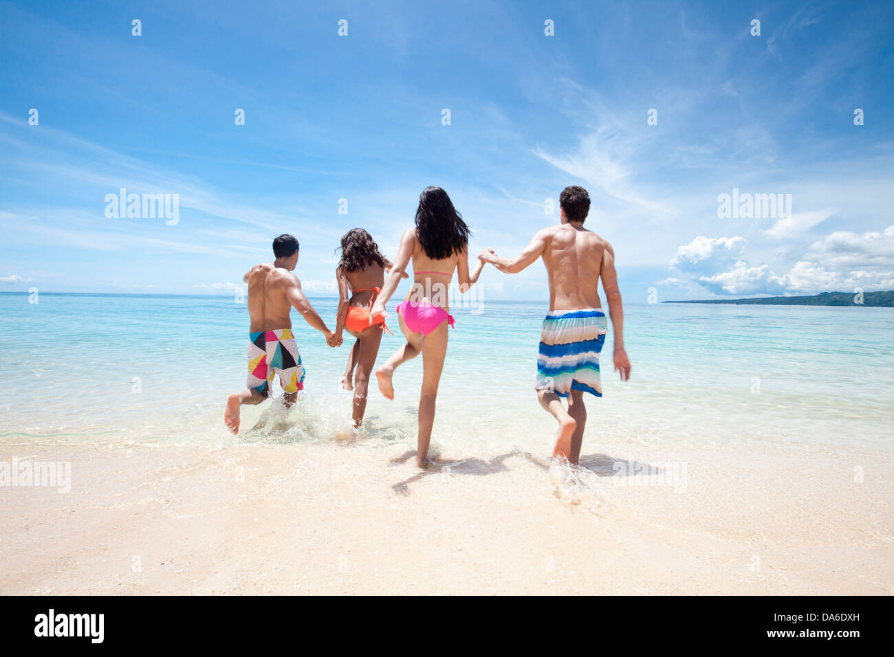 Friends playing on the beach. Stock Photo